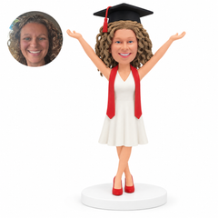 custom bobblehead figure female graduate in a sleeveless dress with both arms raised - custom polymer clay bobblehead figure