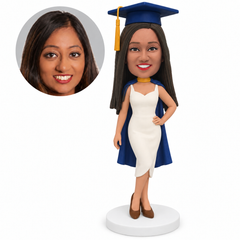 custom bobblehead figure female graduate in a sleeveless dress and cape with one hand on her hip - custom polymer clay bobblehead figure