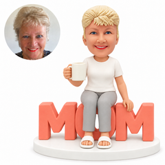 custom bobblehead figure mother seated on mom letters holding a coffee mug - custom polymer clay bobblehead figure