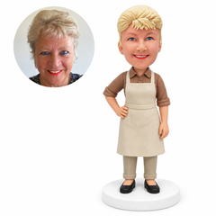 custom bobblehead figure woman in a collared shirt and apron with one hand on her hip