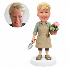 custom bobblehead figure woman in a gardening apron holding a potted plant and trowel