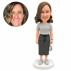custom bobblehead figure woman in a T-shirt and midi skirt with a shoulder bag