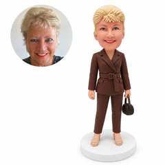 custom bobblehead figure woman in a belted trouser suit holding a small handbag