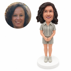 custom bobblehead figure woman in a short-sleeve button shirt and matching shorts with hands clasped