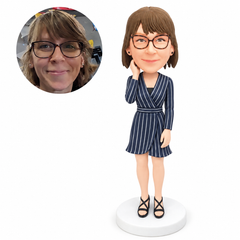 custom bobblehead figure woman in a belted wrap mini dress with one hand by her cheek