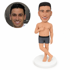 custom bobblehead figure shirtless man in shorts with one hand on his chest