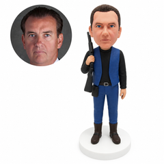 custom bobblehead figure hunter in a vest over a long-sleeve shirt carrying a rifle on one shoulder