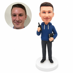 custom bobblehead figure man in a hoodie holding a walkie-talkie and a notebook