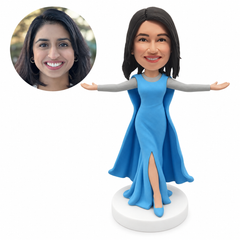 custom bobblehead figure woman in a long gown with a cape and both arms outstretched