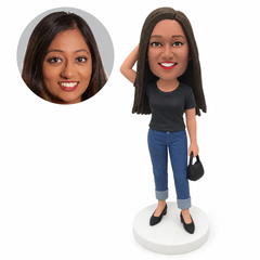 custom bobblehead figure woman in a T-shirt and cuffed jeans with one hand behind her head and a handbag