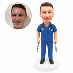 custom bobblehead figure male doctor in scrubs holding two surgical forceps