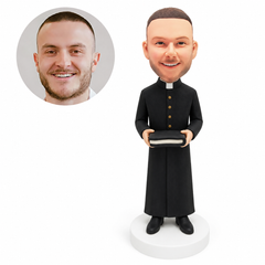 custom bobblehead figure priest in a long button-front cassock holding a closed Bible with both hands