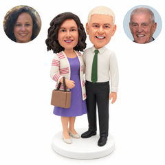 custom bobblehead figures couple with a woman in a cardigan holding a handbag