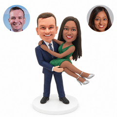 custom bobblehead figures man in a suit carrying a woman in a short dress