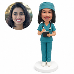 custom bobblehead figure nurse in scrubs holding a pen and a notebook