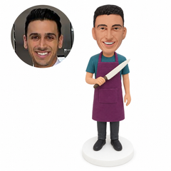 custom bobblehead figure man in a long apron holding a large kitchen knife