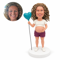 custom bobblehead figure pregnant woman in a cropped T-shirt and shorts holding a heart-shaped balloon