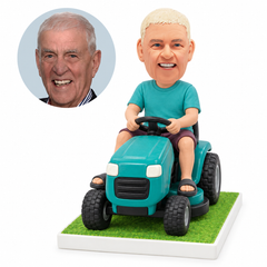 custom bobblehead figure man in a T-shirt and shorts driving a ride-on lawn mower