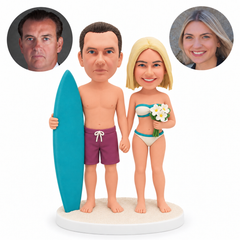 custom bobblehead figures surfing couple holding hands with a surfboard and flowers