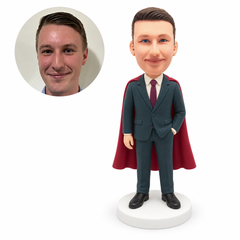 custom bobblehead figure businessman in a suit and cape with one hand in a pocket