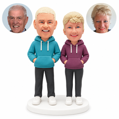 custom bobblehead figures couple with both hands in their hoodie pockets