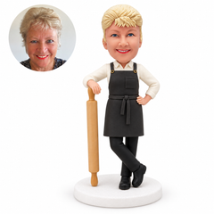 custom bobblehead figure female baker leaning on a giant rolling pin