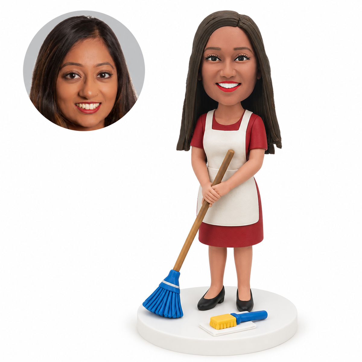 custom bobblehead figure female cleaner holding a broom with both hands beside cleaning tools