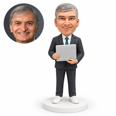 custom bobblehead figure male software engineer holding a closed laptop with both hands