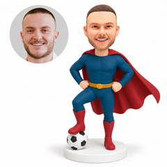 custom bobblehead figure male hero in a cape with both hands on his hips and one foot resting on a soccer ball
