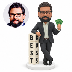 custom bobblehead figure businessman with crossed ankles resting one arm on a best boss block tower while holding banknotes