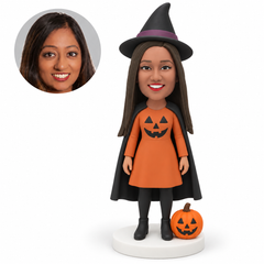 custom bobblehead figure woman in a pumpkin dress and cape with a witch hat and a jack-o-lantern