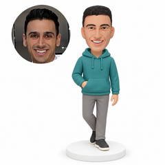 custom bobblehead figure man in a hooded pullover standing with crossed legs and one hand in its front pouch MGA-AC1237
