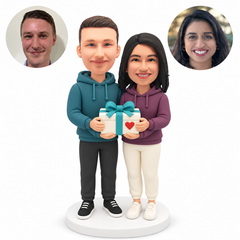 custom bobblehead figures couple in hoodies holding one ribboned gift box together