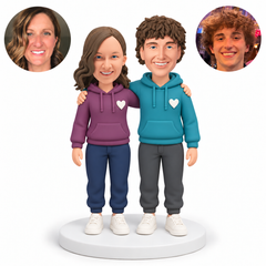 custom bobblehead figures couple in hoodies with both inner arms around each other s shoulders and both outer arms lowered