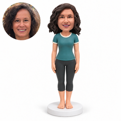 custom bobblehead figure woman in a short sleeve yoga top and capri leggings standing barefoot with both arms lowered with original polymer clay head and matching real photo
