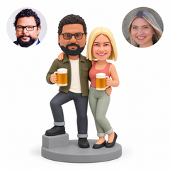 custom bobbleheads figures couple holding beer mugs with the man resting one foot on a low step