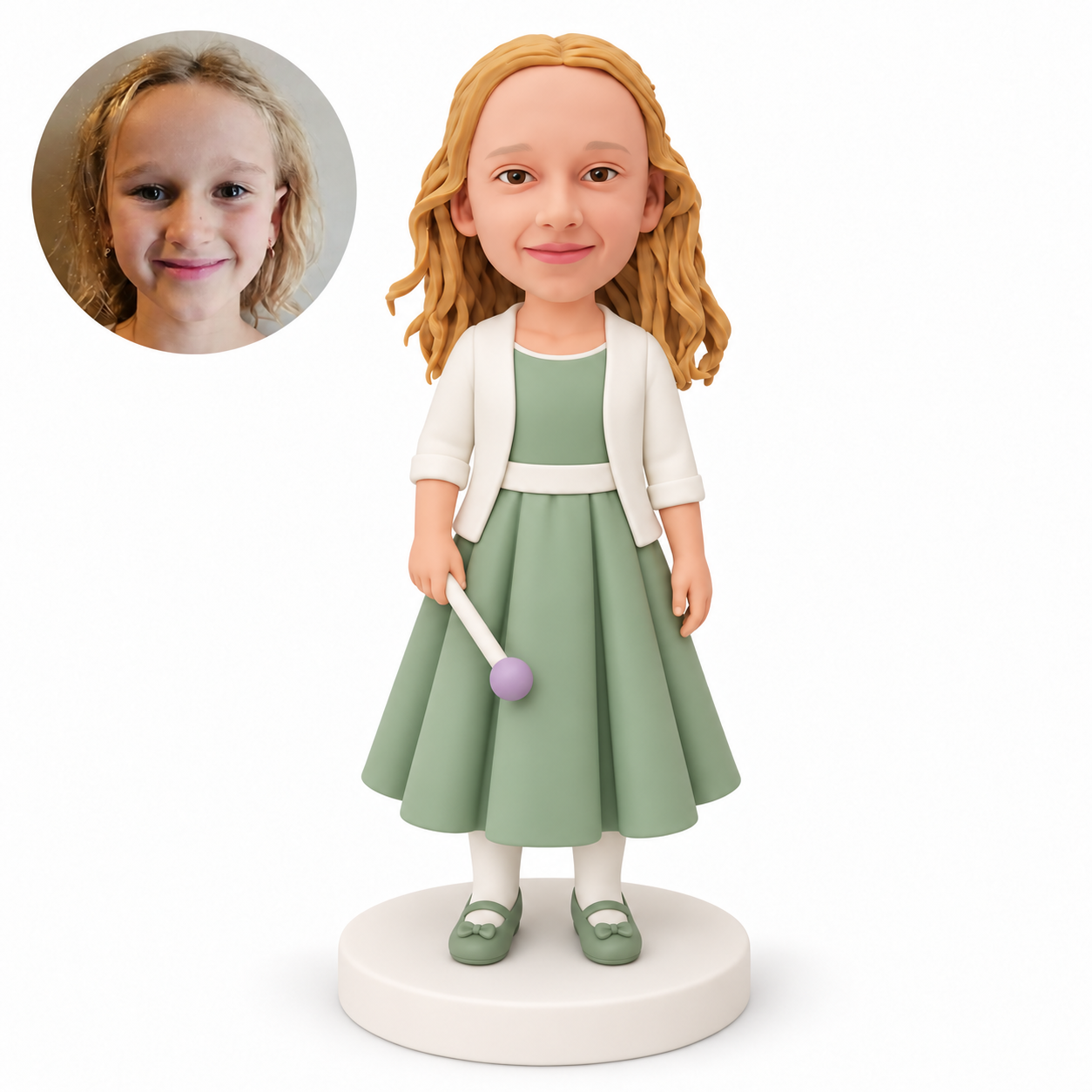 Custom polymer-clay bobblehead girl in a sage green pleated gown holding one lowered round-tipped wand