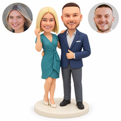 custom bobbleheads figures couple with a woman raising an empty hand near her cheek and resting her other hand on his shoulder