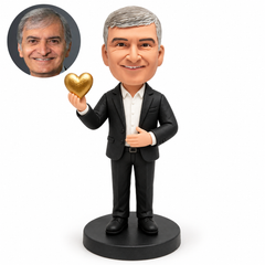mature man holding a raised golden heart