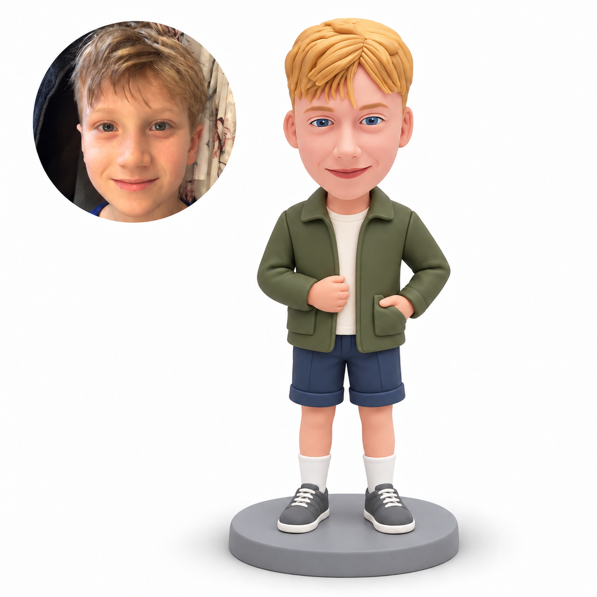 Custom polymer-clay boy in an olive jacket with his left hand inside the jacket patch pocket and right hand at the jacket front, with matching real child portrait
