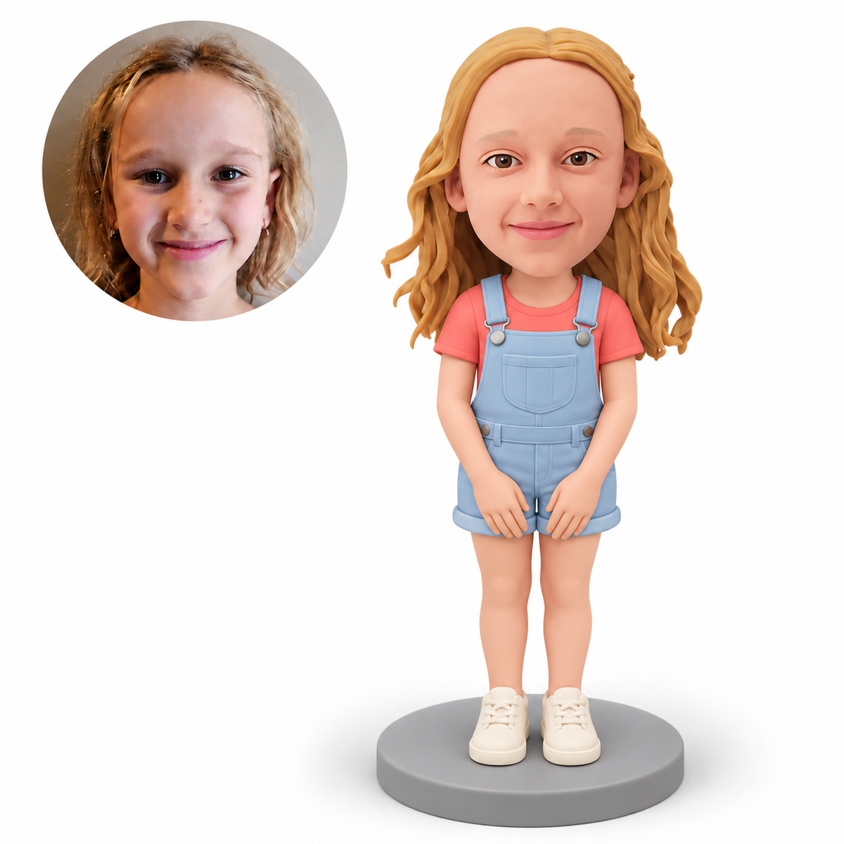 Custom polymer-clay young girl in pale blue short overalls with both hands resting separately low in front of her thighs and both feet planted close, with matching real child portrait
