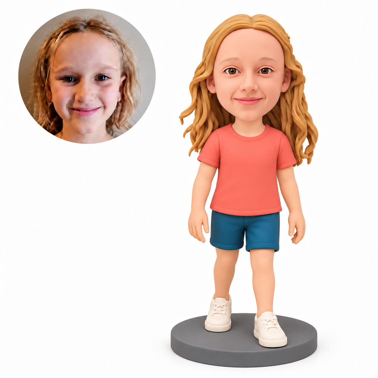 Custom polymer-clay girl in a coral T-shirt and teal shorts, standing with both empty arms down beside her thighs and her left foot forward on a plain grey round base, with matching real child portrait