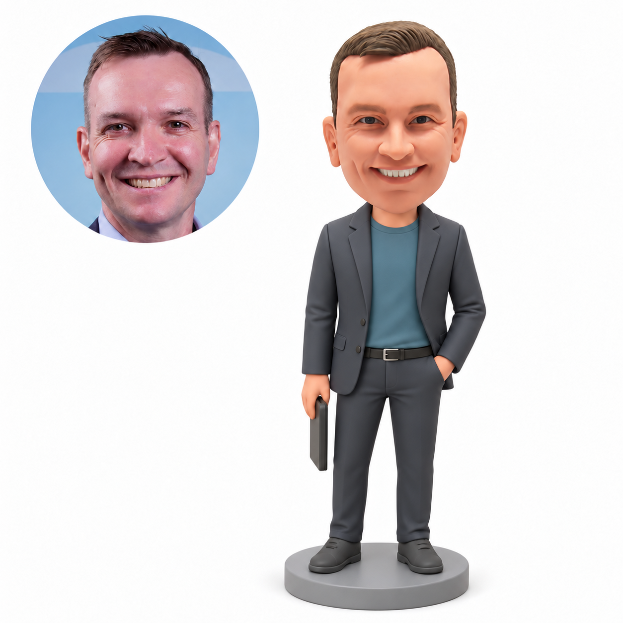 Custom polymer-clay man in a grey blazer and teal shirt, holding the upper edge of a slim upright rectangular accessory in his lowered right hand with his left hand in a trouser pocket, on a plain round base with matching real portrait