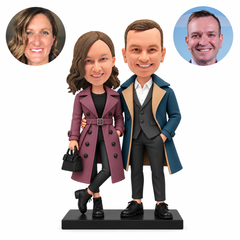 Custom polymer-clay couple in long coats, her handbag and bent crossed leg, his arm around her waist, MGA-AC1783