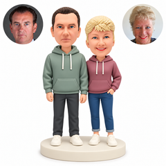 Custom clay couple in hoodies with the man’s empty hands lowered and the woman’s left hand in her trouser pocket, with paired photo references