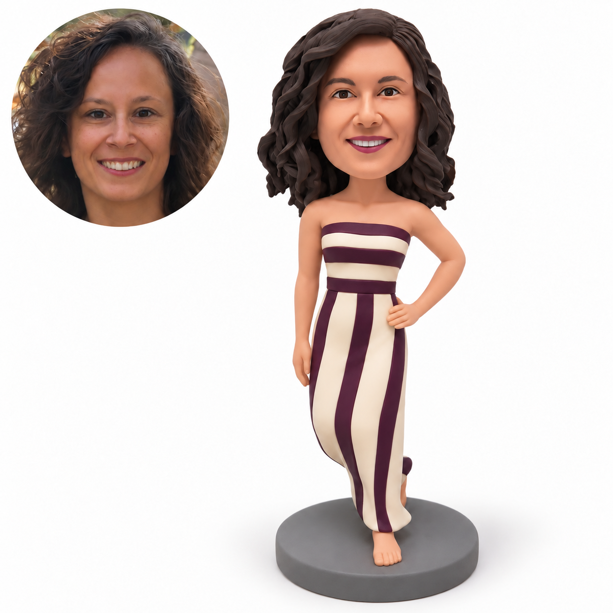 Clay woman in a fitted plum and ivory striped strapless long gown, left hand on hip, right arm down, bent knee and bare front foot on gray round base, with matching real portrait.