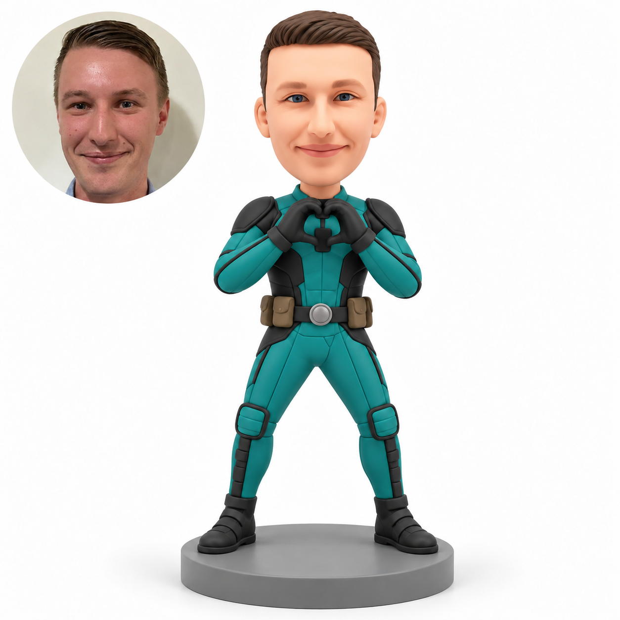 Clay man in a teal hero suit, curved gloved hands joined at his upper chest, two brown hip pouches and planted boots on a gray base, with matching real portrait.