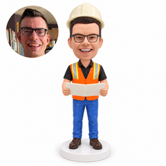 custom bobblehead figure construction manager holding folded plans in a safety vest