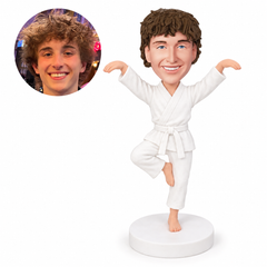 custom bobblehead figure martial artist in a white gi balancing on one leg with both arms raised
