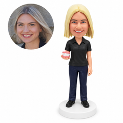 custom bobblehead figure female dentist in a polo shirt holding a denture model